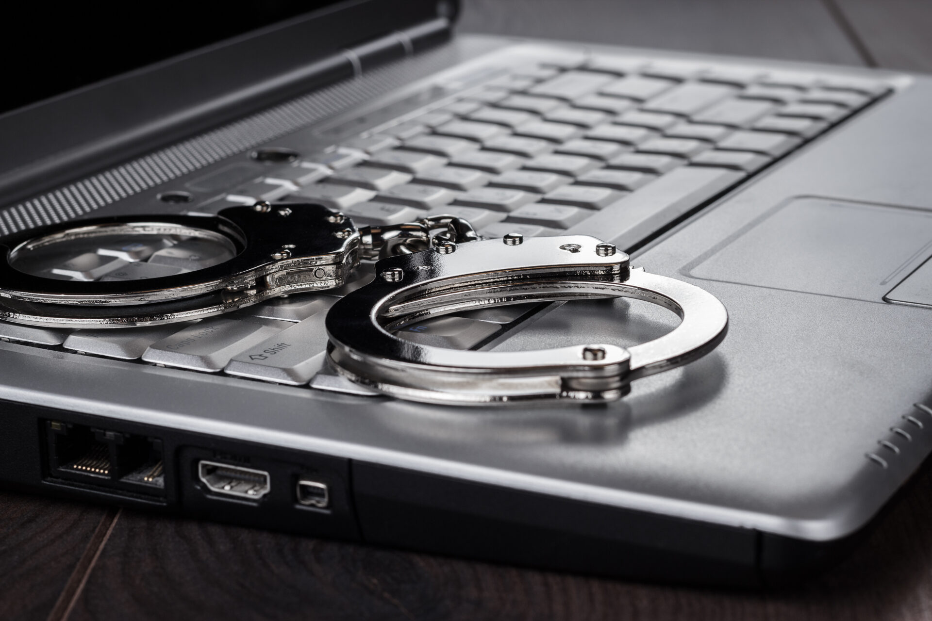 Handcuffs On Laptop Cyber Crime Concept